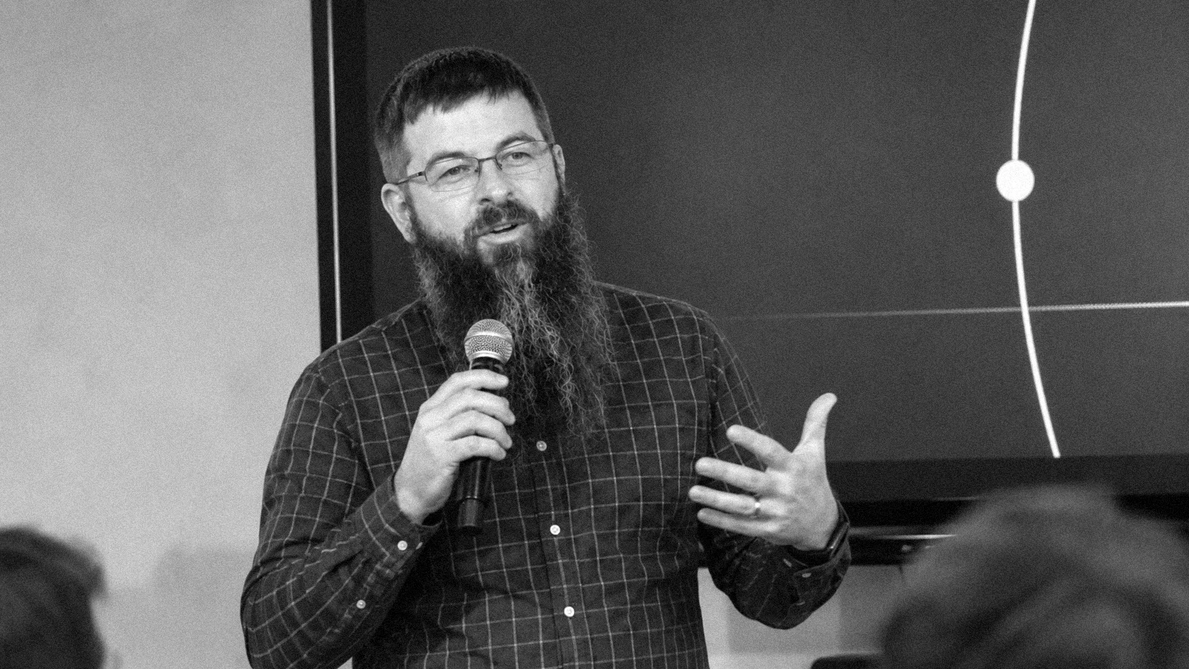Justin McCarthy speaking on stage